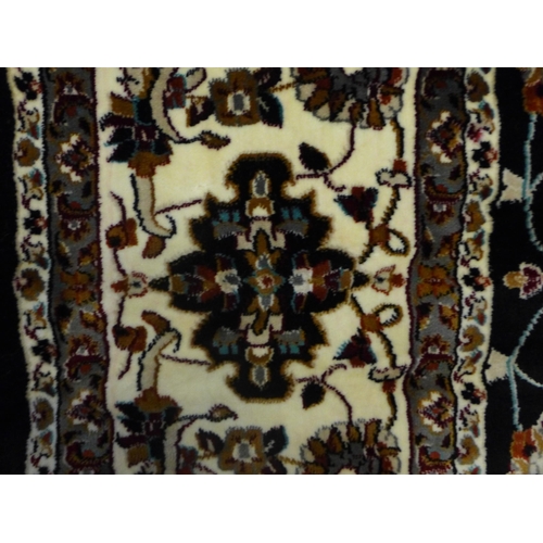 1553 - A black ground fine woven Iranian carpet with all over floral pattern