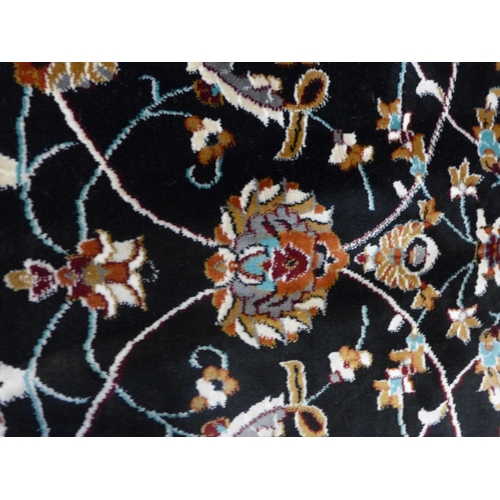 1553 - A black ground fine woven Iranian carpet with all over floral pattern