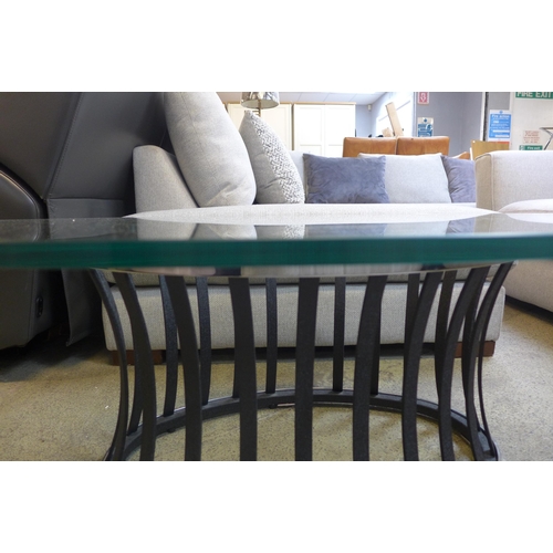 1591 - A glass topped oval coffee table with metal base