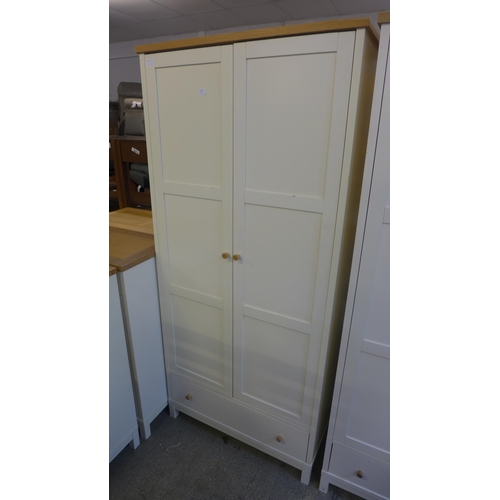 1631 - An oak and cream double wardrobe * this lot is subject to VAT