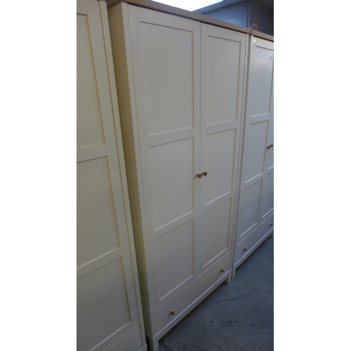 1632 - An oak and cream double wardrobe * this lot is subject to VAT