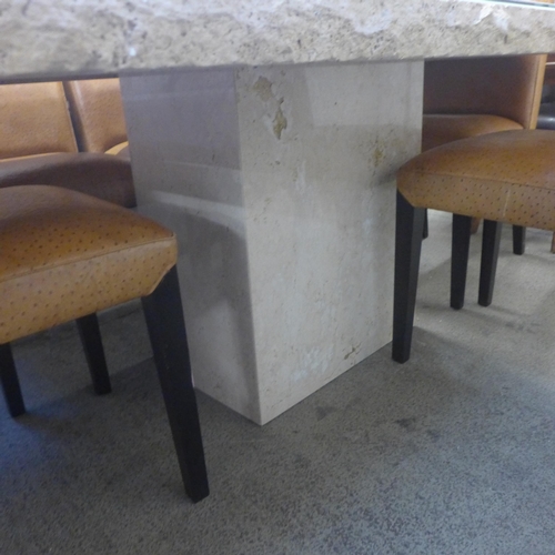 1600 - A Travertine dining table and six ostrich leather upholstered chairs