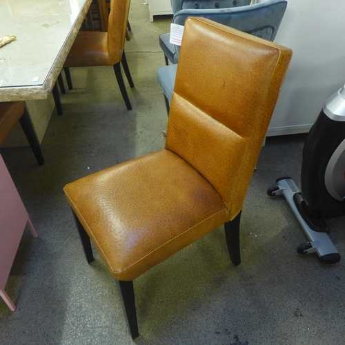 1600 - A Travertine dining table and six ostrich leather upholstered chairs