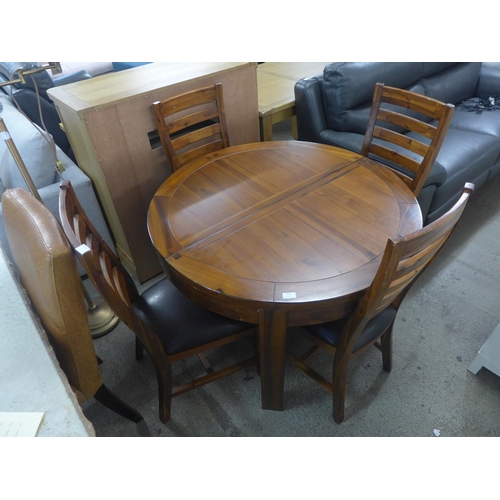 1602 - A Kember circular extending dining table and four dining chairs