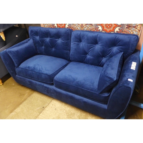 1431 - A blue velvet Hoxton three seater sofa - RRP £799