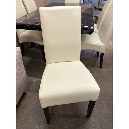 1447 - A black and white marble effect dining table and six white leather effect chairs