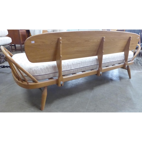 18 - An Ercol Blonde ash and beech 355 model studio couch. Purchased by the vendor from Hopewells, Nottin... 