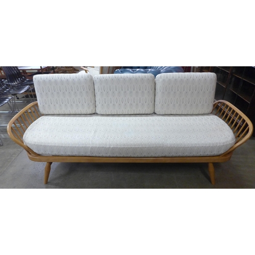 18 - An Ercol Blonde ash and beech 355 model studio couch. Purchased by the vendor from Hopewells, Nottin... 