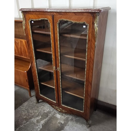 103 - A 19th Century French rosewood, gilt metal and marble topped two door vitrine