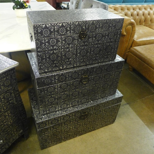 1348 - A set of three metal patterned storage trunks