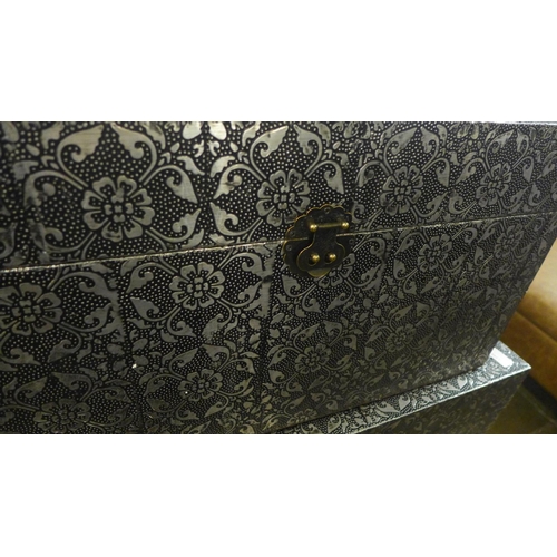 1348 - A set of three metal patterned storage trunks