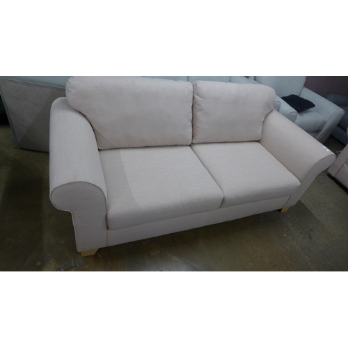 1385 - A candy floss fabric upholstered three seater sofa