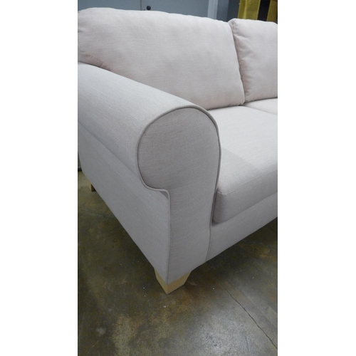 1385 - A candy floss fabric upholstered three seater sofa