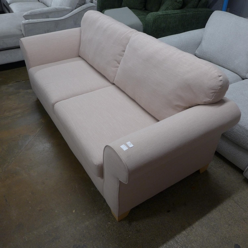 1385 - A candy floss fabric upholstered three seater sofa