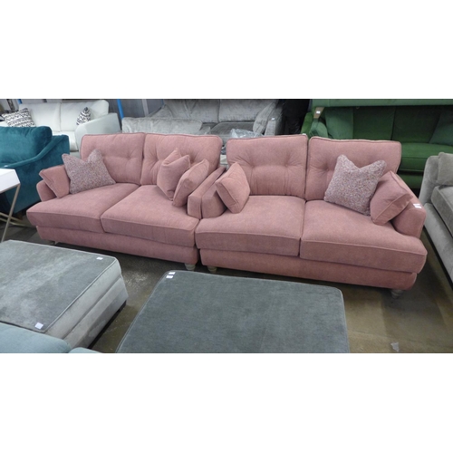 1407 - A pair of raspberry velvet upholstered two seater sofas with multi coloured scatter cushions