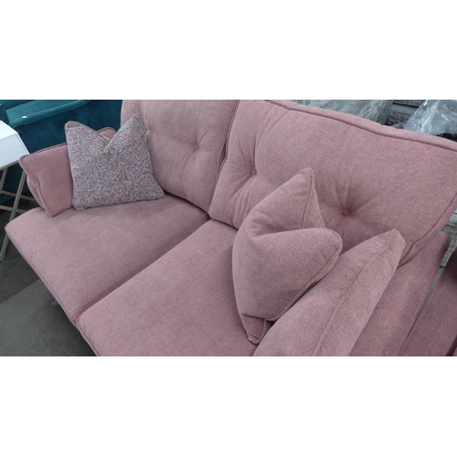 1407 - A pair of raspberry velvet upholstered two seater sofas with multi coloured scatter cushions