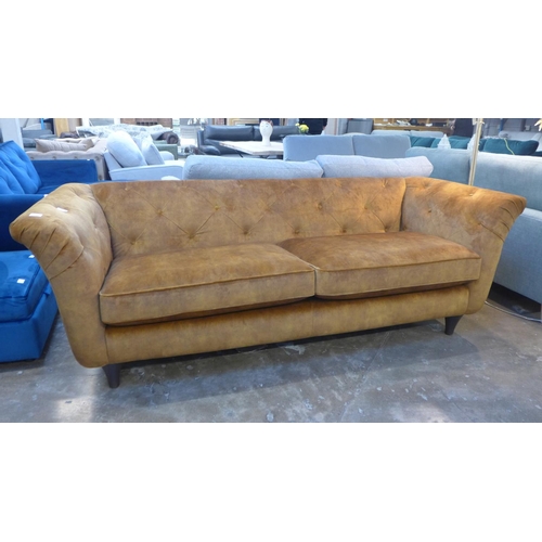 1410 - A Jaipur amber velvet button backed three seater sofa - RRP £1299