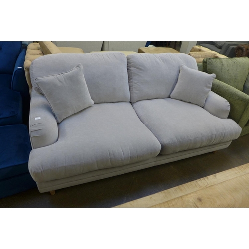 1451 - A light grey velvet upholstered large three seater sofa