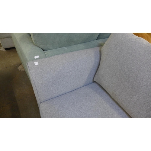 1454 - A mid grey fabric upholstered 2.5 seater sofa