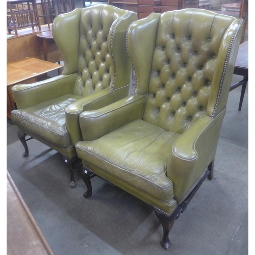 135 - A pair of Queen Anne style mahogany and green leather wingback armchairs