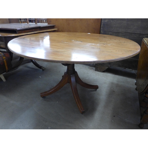 210 - A Regency mahogany oval tilt-top centre table