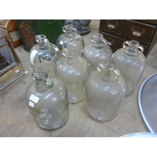 281 - A set of six glass demi-Johns and another