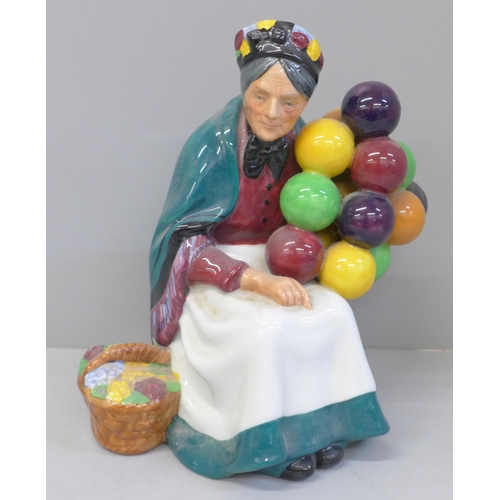 612 - A Royal Doulton figure, The Old Balloon Seller and Sir Winston Churchill, Churchill a/f