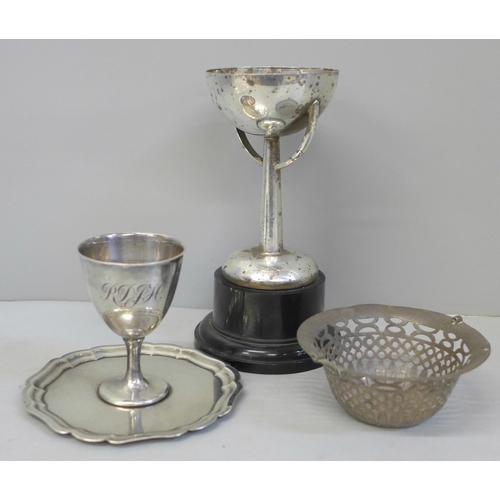 649 - A pierced basket, no handle, a silver plated trophy and egg cup and tray