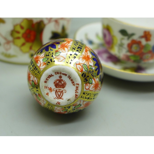 665A - A Royal Crown Derby Imari miniature bottle vase, tea pot and cauldron, a pair of Dresden miniature c... 