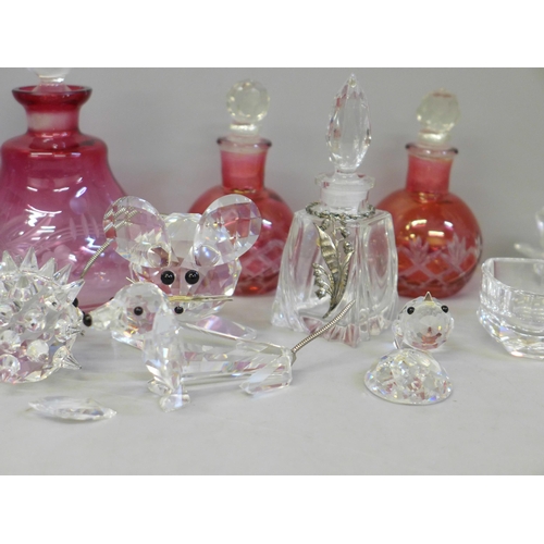 689 - Swarovski crystal animals, scent bottles, etc., including a pair of cranberry scents