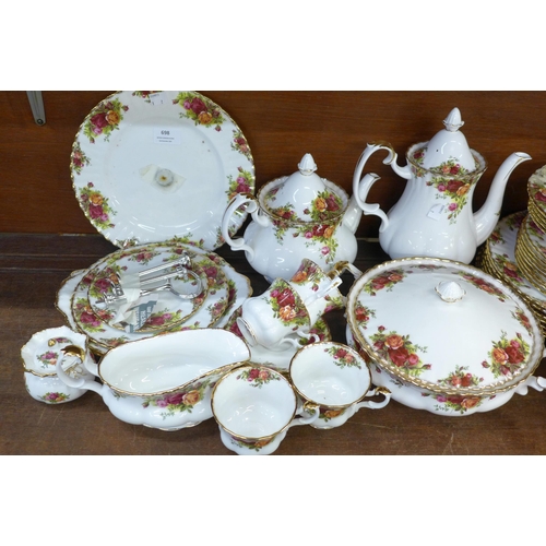 698 - Royal Albert Old Country Roses tea and dinnerwares, teapot, coffee pot, two cake stands, plates, bow... 