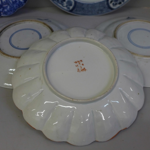 726 - Four Chinese export blue and white plates, a Kutani plate and four white china models of horses