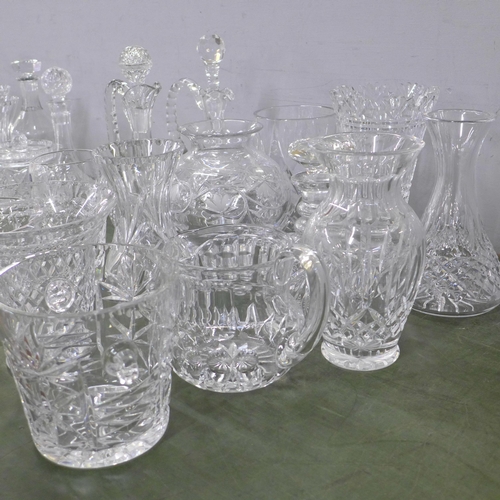 813 - A large collection of crystal and glass decanters, jugs, ice bucket, vases, fourteen in total **PLEA... 