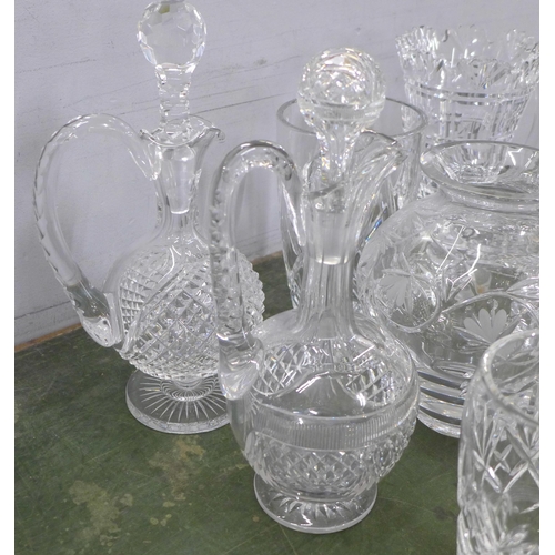 813 - A large collection of crystal and glass decanters, jugs, ice bucket, vases, fourteen in total **PLEA... 