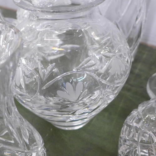 813 - A large collection of crystal and glass decanters, jugs, ice bucket, vases, fourteen in total **PLEA... 