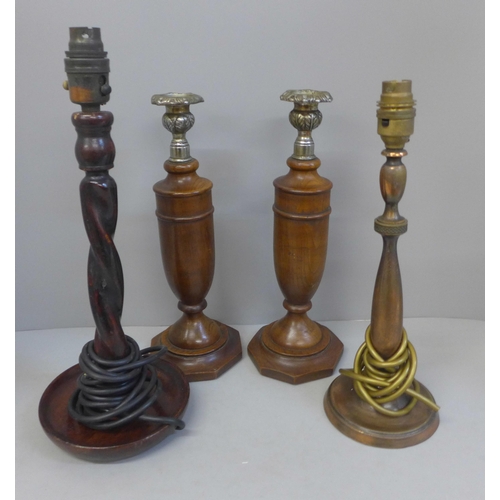 823 - A pair of wooden candlesticks and two table lamp bases; one brass, the other barleytwist