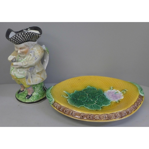 829 - A Victorian majolica bread plate, Adams & Bromley, geranium pattern, unmarked, and a Toby jug