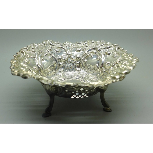 881 - An embossed pierced dish on four hoof feet, Birmingham 1901, 78g