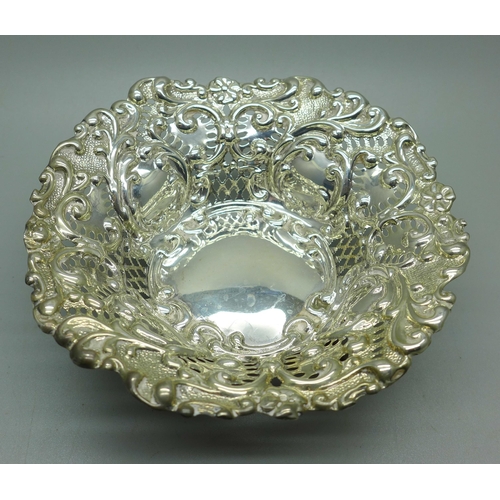 881 - An embossed pierced dish on four hoof feet, Birmingham 1901, 78g