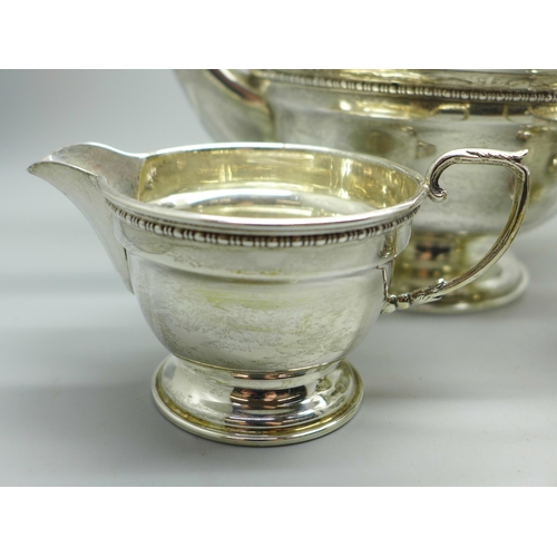 893 - A silver three piece tea service, Birmingham 1933, 614g