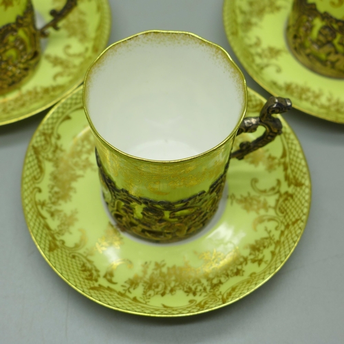 895 - Four Staffordshire 'Eggshell' coffee cans and saucers with four silver holders, William Comyns, Birm... 