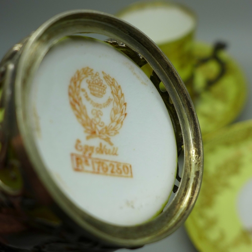 895 - Four Staffordshire 'Eggshell' coffee cans and saucers with four silver holders, William Comyns, Birm... 