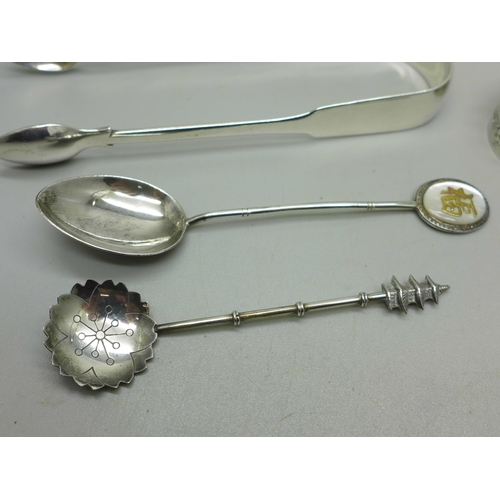 898 - A small silver pill box, two silver spoons and a pair of silver sugar bows, 81g