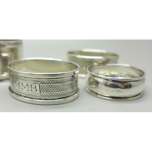 924 - Five silver napkin rings, one a/f, two others and a thimble, weight of silver 57g