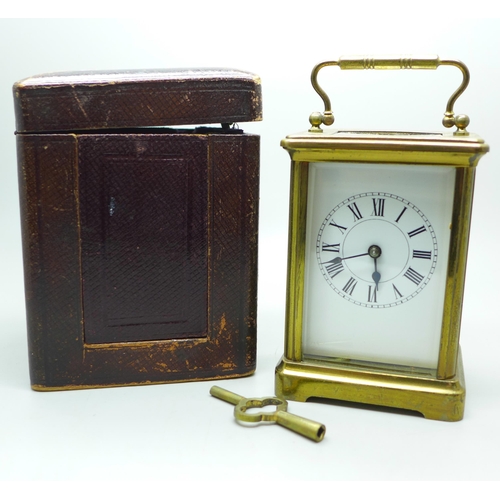 936 - A French gilt brass and four glass sided carriage clock in leather travel case