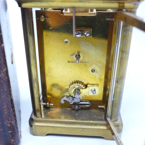 936 - A French gilt brass and four glass sided carriage clock in leather travel case