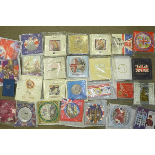 979 - Twenty-eight coin sets, dating from 1986-2006, including a Trafalgar commemorative crown, Coronation... 