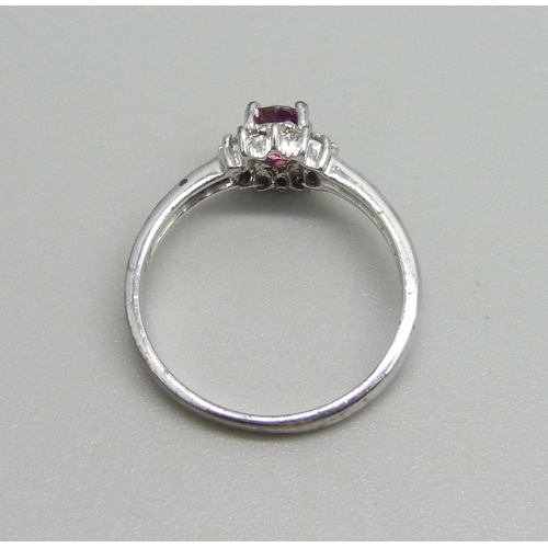 1018 - A 9ct white gold ring set with a garnet and white stone halo, 2.7g, N/O