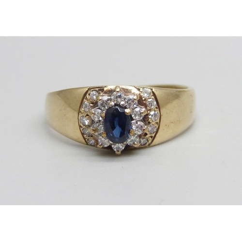 1021 - A 9ct gold, diamond and sapphire ring set with 20 diamonds and a central sapphire, 1.7g, M