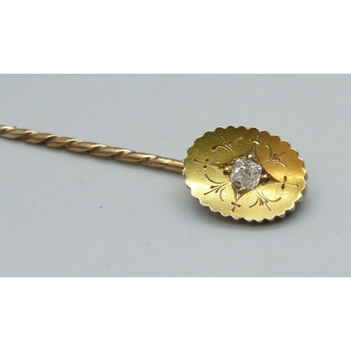 1024 - A yellow metal stick pin set with a diamond, 2.6g, cased